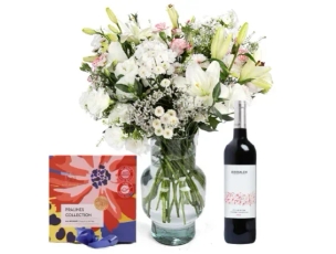 a white flowers, chocolate & red wine bottle