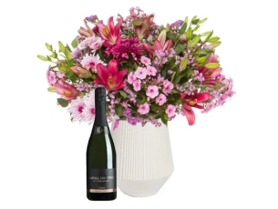 An elegant bouquet with pink festive shades & Cava bottle