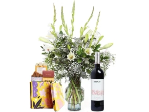 a white flowers, chocolate & red wine bottle