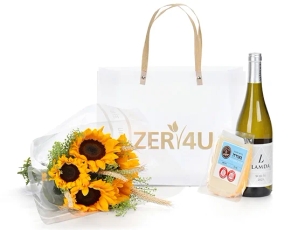 A box with white wine, cheese and a small sunflower bouquet.
