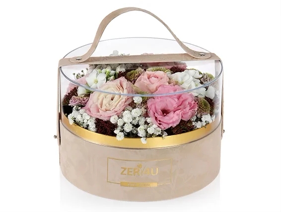 roses flower arrangement in a round velvet box