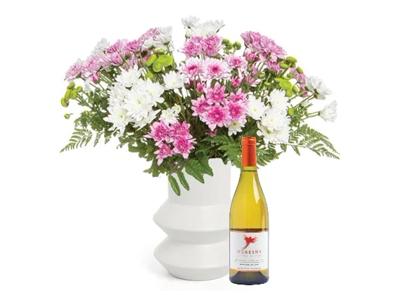 Daisies in a white ceramics vase & wine