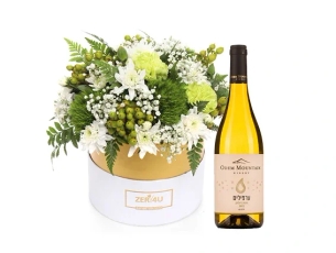 White flower arrangement and white wine
