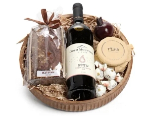 Box with red wine & honey cake & honey jar & chocolate and black pomegranate for decoration