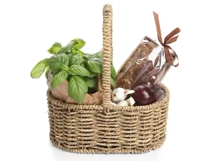 A box with honey cake, a spice pot, chocolate and a black pomegranate for decoration.