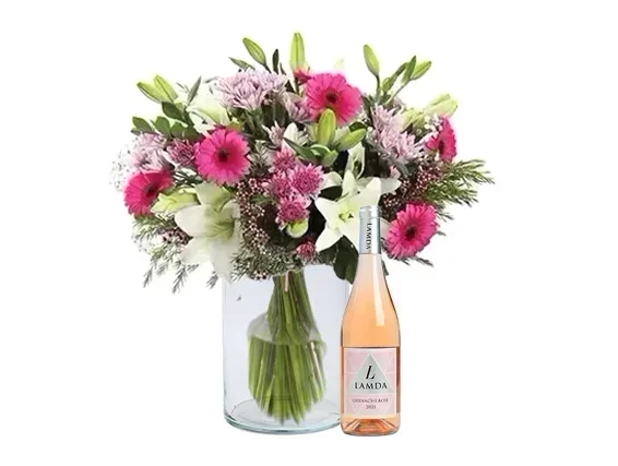 Abundant and festive pink Bouquet in a glass vase + rose wine